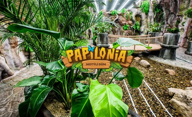 Vstupní značka Motýlí dům v Praze mezi tropickými rostlinami