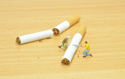Miniature figures breaking cigarette